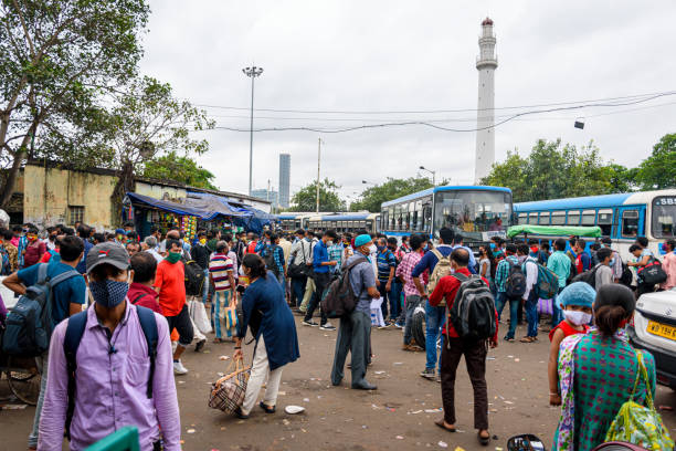 People gathered in the bus stand waiting for the bus with masks during unlock period in Kolkata, West Bengal, India on October 2020 stock photo