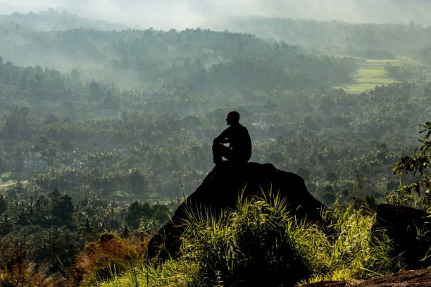 istock man backlight watching the amazing view of mountain layers covered with white mist at dawn 1283720206