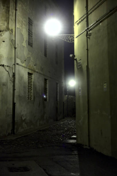 istock Alley in an italian town during a light rainfall at night 1283721053