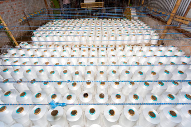 istock A pattern of white cotton spools with threads. An old system manual loom machine for clothing. 1283721220