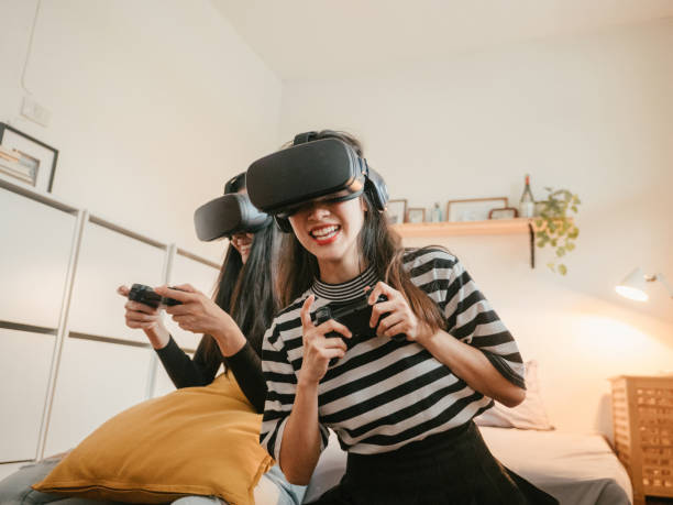 istock Asian couple lesbians playing a VR device at home. 1283722282