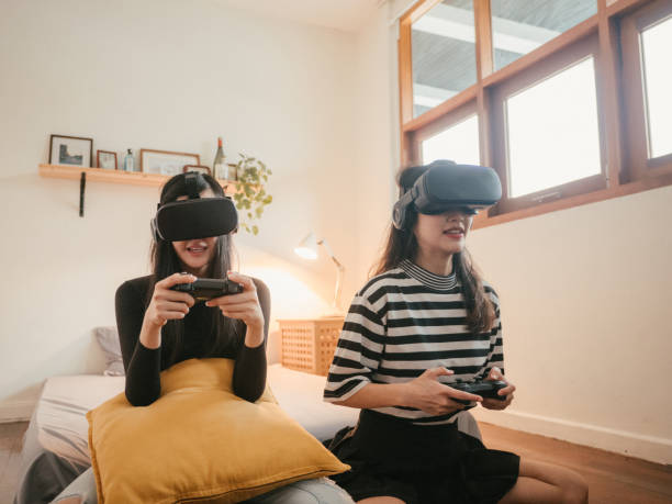 istock Asian couple lesbians playing a VR device at home. 1283722304