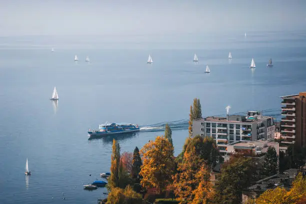 Paddle steamer and other boats are sailing on an autumn day in Montreaux.