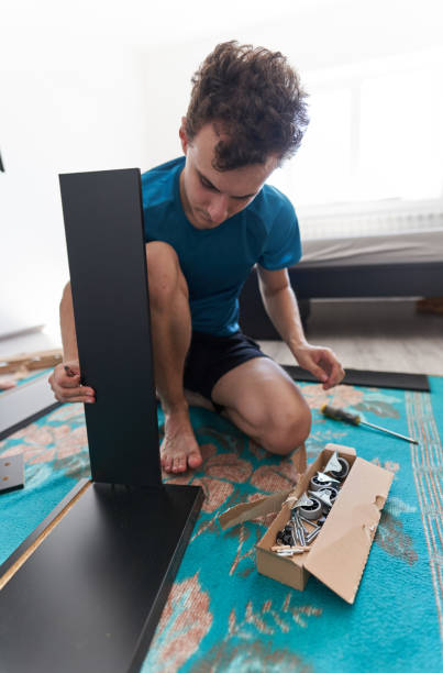 istock Man assembling his new furniture 1283725710