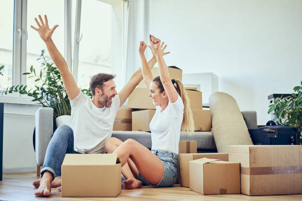 istock Happy couple moving to new home -  having fun celebrating 1283725807