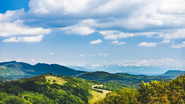 istock French nature rolling landscape in spring with green hills and Alps mountains 1283725900