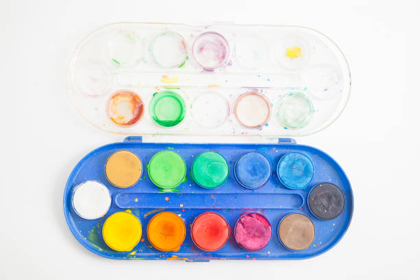 istock Used watercolor paint palette on white 1283726082