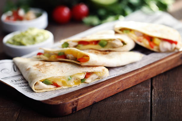 istock Typical mexican quesadillas with chicken, pepper and cheese on wooden board 1283727113