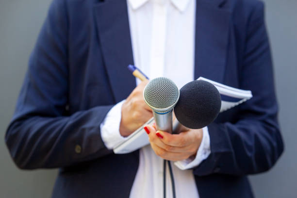 istock Broadcast journalist at press conference or media event. Journalism concept. 1283727223