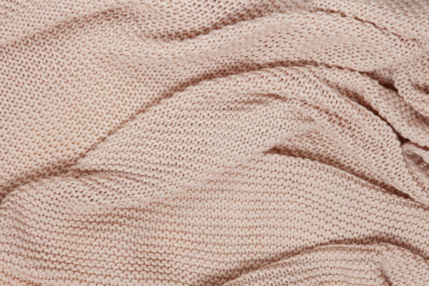 istock Textured surface of knitted cotton wave plaid, top view. Soft dusty pink pastel wool backdrop. Seasonal cosiness flat lay. Scandinavian minimal style. Stay at home, cozy, femininity concept 1283728783