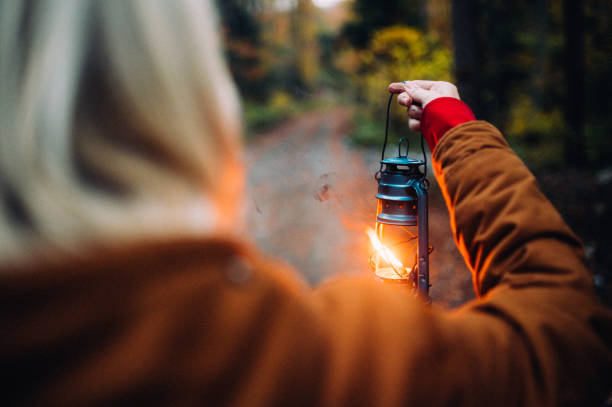 istock Woman with lantern in the forest 1283729272