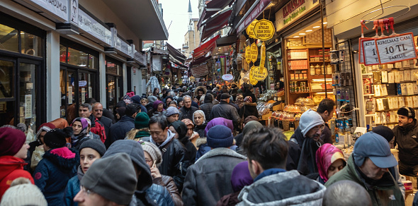 Istanbul, Turkey- Jan 25, 2018: Mahmut Pasa is really a famous street of shops and not a bazaar, Eminönü, Turkey. Crowded shopping street where the people are walking around and buying goods.
