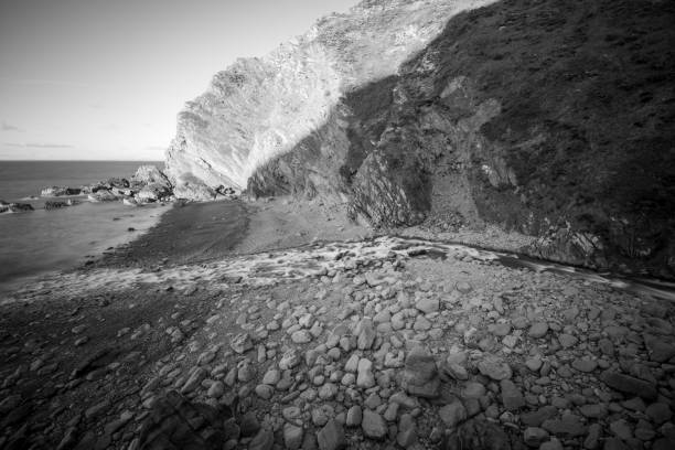 Long exposure of the river Heddon flowing onto the beach at Heddons Mouth in Exmoor