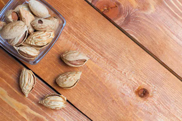 Photo of Almonds  popular, healthy, copy space, on a rustic background of wood, close-up.