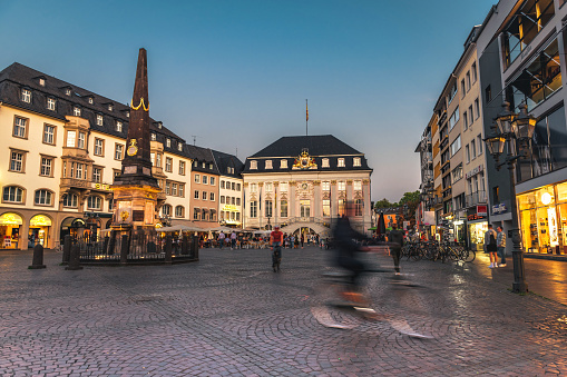 illuminated market square with old town hall in Bonn at blue hour in late summer