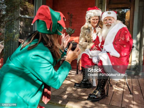 Santa And Mrsclause Pose For Photos For Elf Stock Photo - Download Image Now - Santa Claus, Elf, Mrs Claus