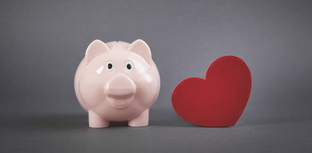 istock Piggy bank with red heart. 1283735120