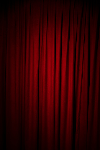 Empty stage with red velvet curtains. Theater stage with gray in-stage curtain and parquet floor