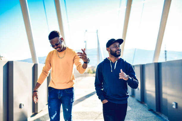 istock Two Modern African Males Dancing And Rapping While Walking On Bridge 1283735859