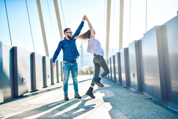 istock Male Spinning His Girlfriend In Dance On Bridge 1283736177