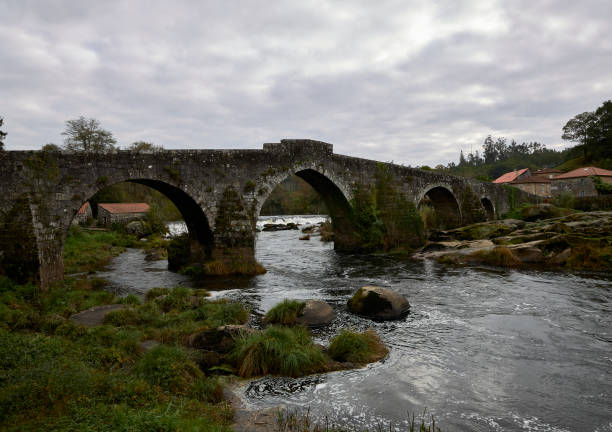 istock Medieval bridge over a river on the Camino de Santiago 1283737362