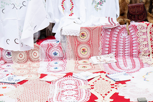 Hand craft crochet doilies with different patterns and lace mat items with floral ornaments on street sale display, detail