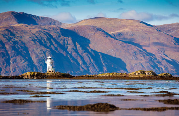 Scotland West Coast Lighthouse and mountains from the peninsula of Port Appin, Scotland argyll and bute stock pictures, royalty-free photos & images