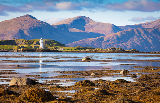 Lighthouse and mountains from the peninsula of Port Appin, Scotland