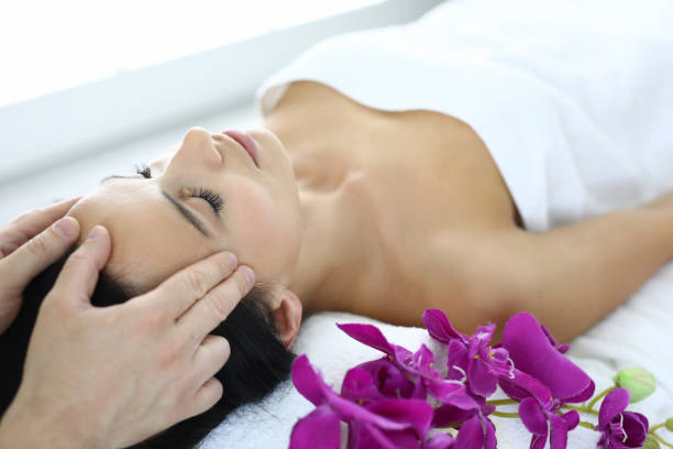 istock Portrait of woman whose master does an acupressure face massage. 1283738020