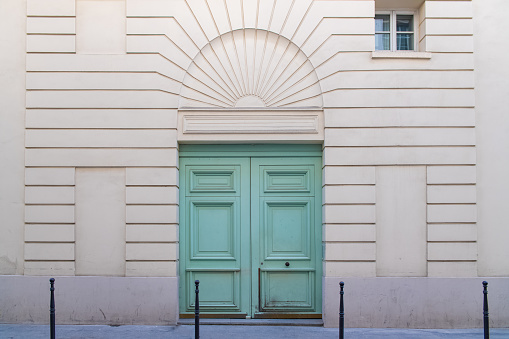 Paris, an old wooden door, typical building in the Marais