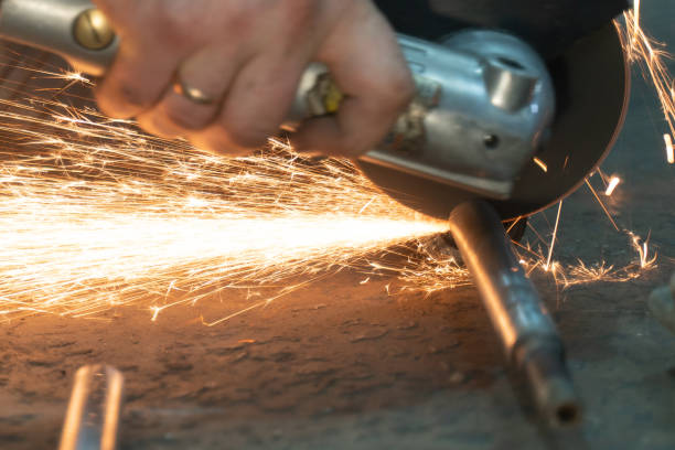 istock sparks flying from under the grinder when cutting iron. selective focus 1283740392