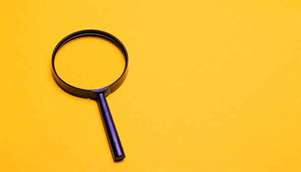 istock Magnifier on a yellow background. Space to copy and paste text or illustrations 1283741701