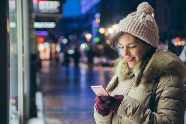 istock Woman checking messages on phone in the winter 1283741784