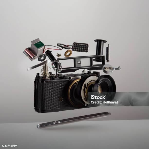 Parts And Components Of A Disassembled Analog Vintage Film Camera Floating In The Air On White Background Stock Photo - Download Image Now