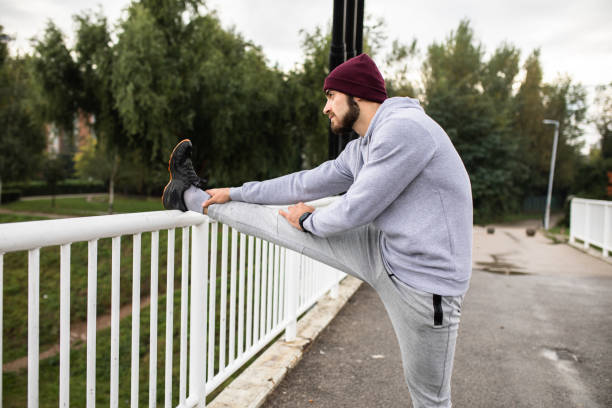 istock A fit young man stretching on a bridge 1283742838
