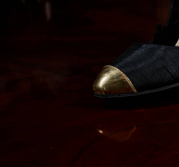 old woman's black shoe with golden tip - skeg imagens e fotografias de stock