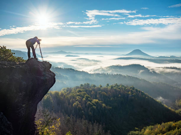istock Photographer framing scene in viewfinder. Man use camera 1283744681