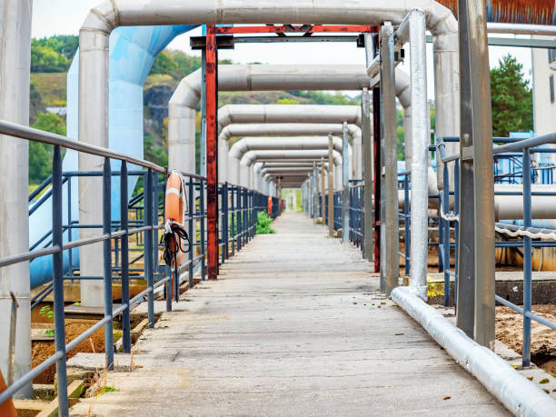 istock Industrial pipelines in loop on pipe bridge. Tanks field 1283745754