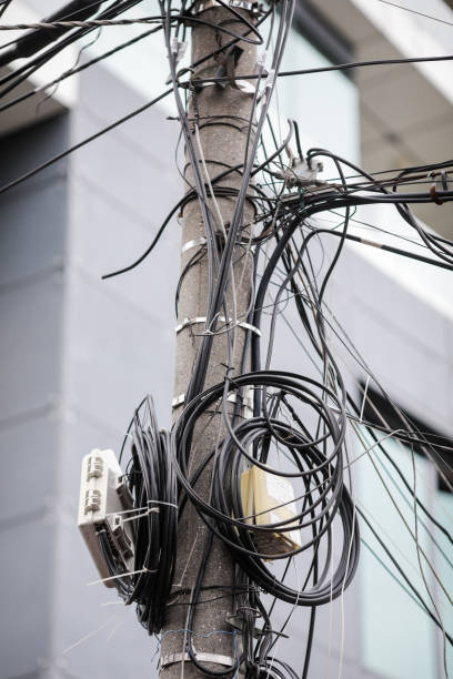 istock Many unorganised internet and TV cables on a concrete pole in Bucharest. 1283746044