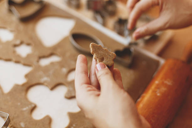 istock Person holding tree gingerbread cookie on background rustic table. Christmas 1283747238