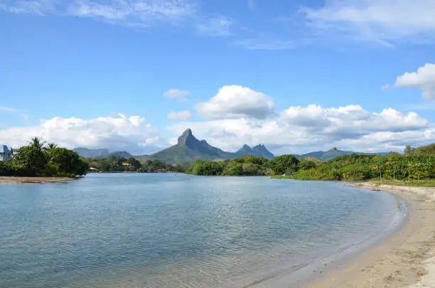 View of Tamarin Bay in Mauritius, including the beach and mountains in the background.