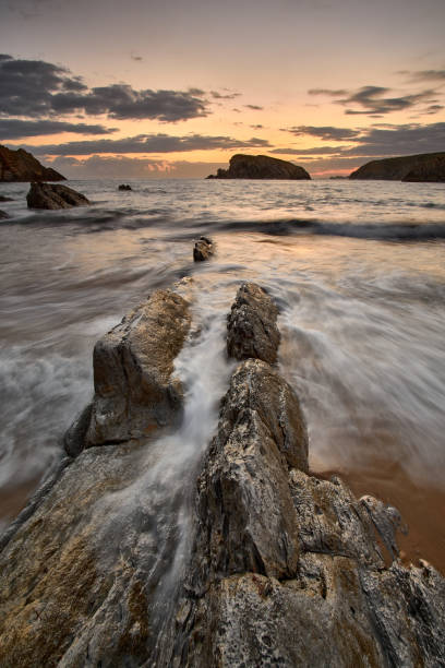 istock Beautiful sunrise at Playa de la Arnia in Liencres SAntander 1283748493