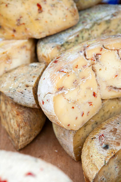 istock Goat cheese with herbs and spices on a creamery stall 1283751207