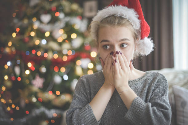 istock young woman in christmas interior ( negative emotions) 1283751217