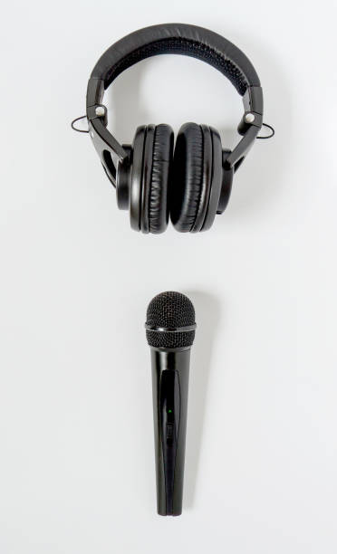 istock Black professional microphon and headphones on white backgound. Top view 1283751230