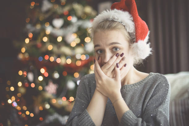 istock young woman in christmas interior ( negative emotions) 1283753317