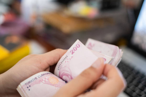 istock Close up to man's hand Counting Turkish Money 1283755027