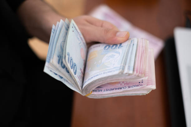 istock Close up to man's hand Counting Turkish Money 1283755072