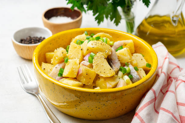 istock Potato salad with salted herring and onion in ceramic bowl 1283755251