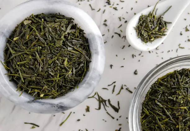 Overhead view of Japanese sencha green tea in bowl.  Close-up with horizontal composition.